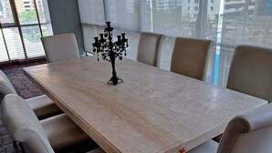 A conference table with six chairs, a black chandelier, and large windows with blinds. - 6D - 3 Bedroom Downtown Apartment With Shared Pool (Bangkok)