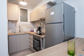 Apartment | Private kitchen | Full-sized fridge, oven, electric kettle, toaster - Charming Urban Oasis at Megaro Mousikis (Athens)