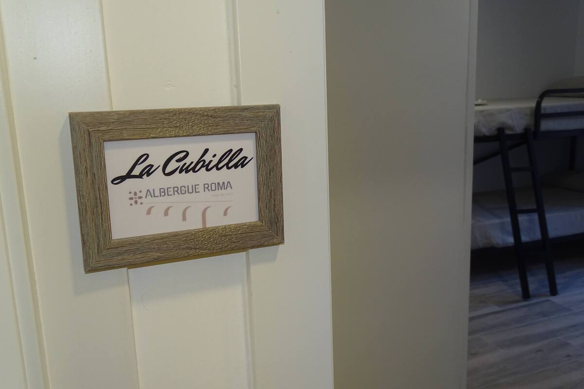 Señal enmarcada con el texto 'La Cubilla' y 'Albergue Roma', que indica un albergue en Roma.