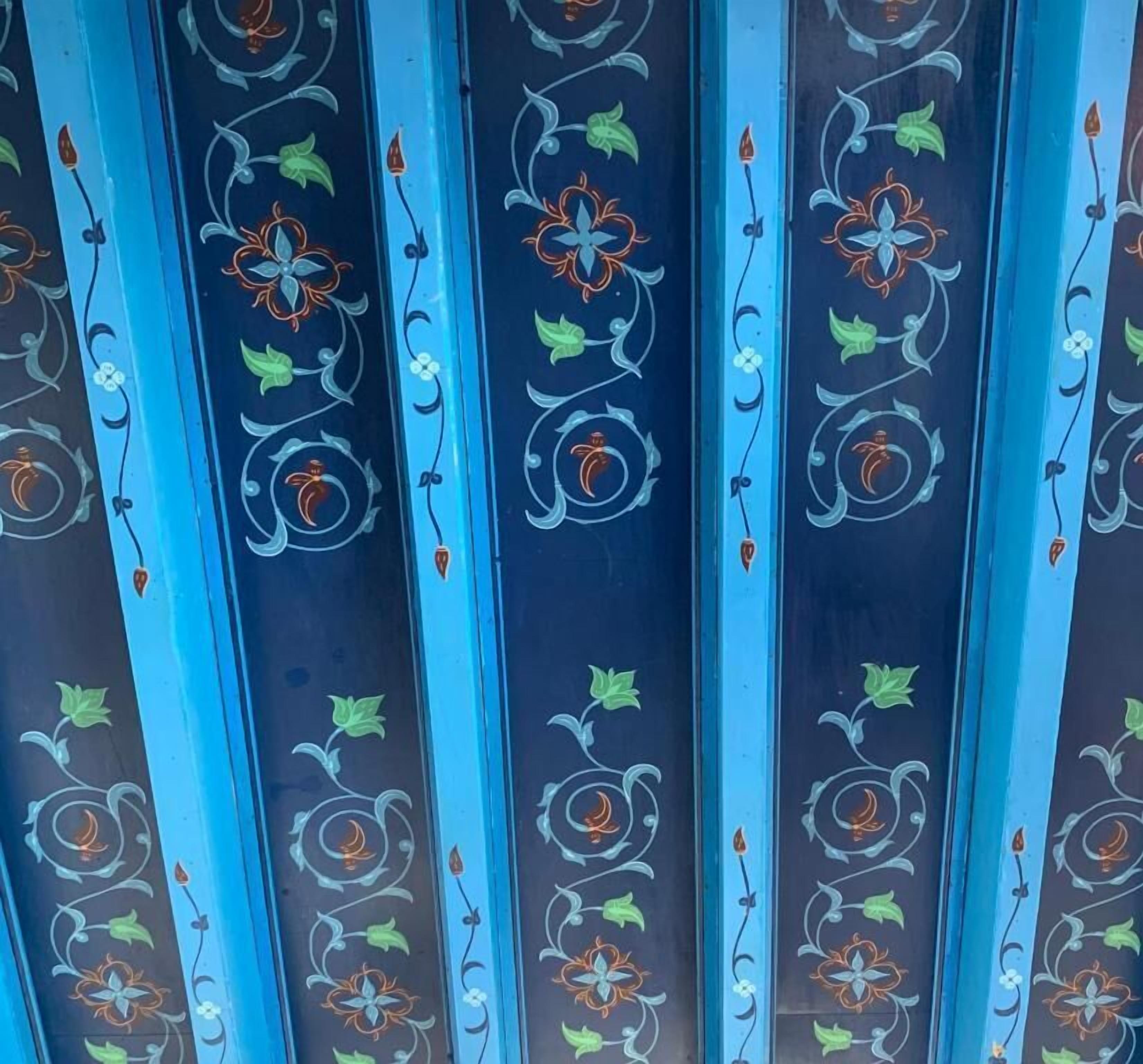 A series of vertical panels with intricate floral and vine patterns.