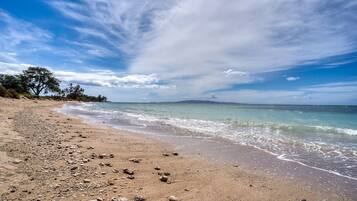 On the beach, white sand, beach umbrellas, beach towels
