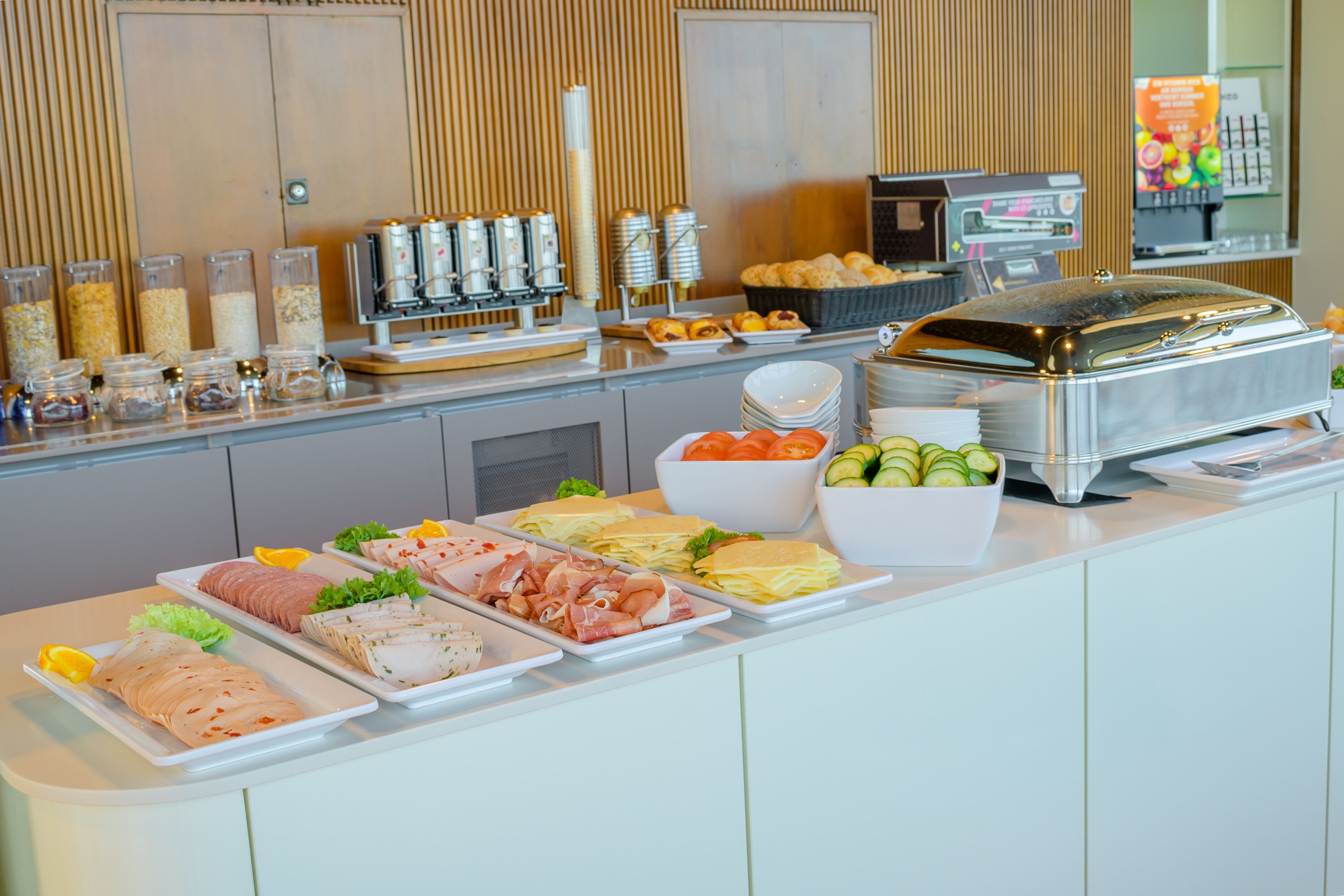 Un buffet proposant une variété de plats, notamment des viandes, des fromages et des légumes.