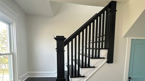 A staircase with black railings and white steps, leading to a door with a light blue frame. - Luxury Boho Bay House. Balcony with Sunset Views, Near Casinos & Beach (Pleasantville)