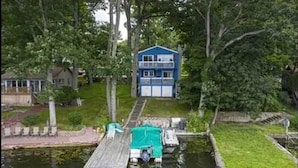 A house with a dock extending into a body of water, surrounded by greenery. - Lake Hopatcong cottage with dock; Permit #2023-6
(Hopatcong)