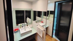 A modern bathroom with two sinks, a large mirror, and recessed ceiling lights. - Lovely Condo Best City Location. (Mexico City)