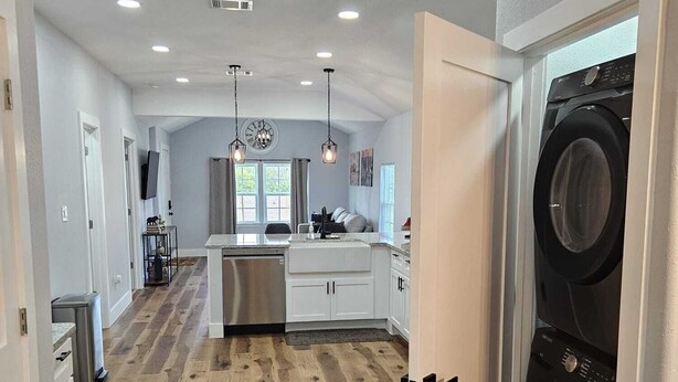 A modern kitchen with white cabinets, a stainless steel refrigerator, and a central island. - ~ Houston Heights 4-plex with patio ~ (Houston)