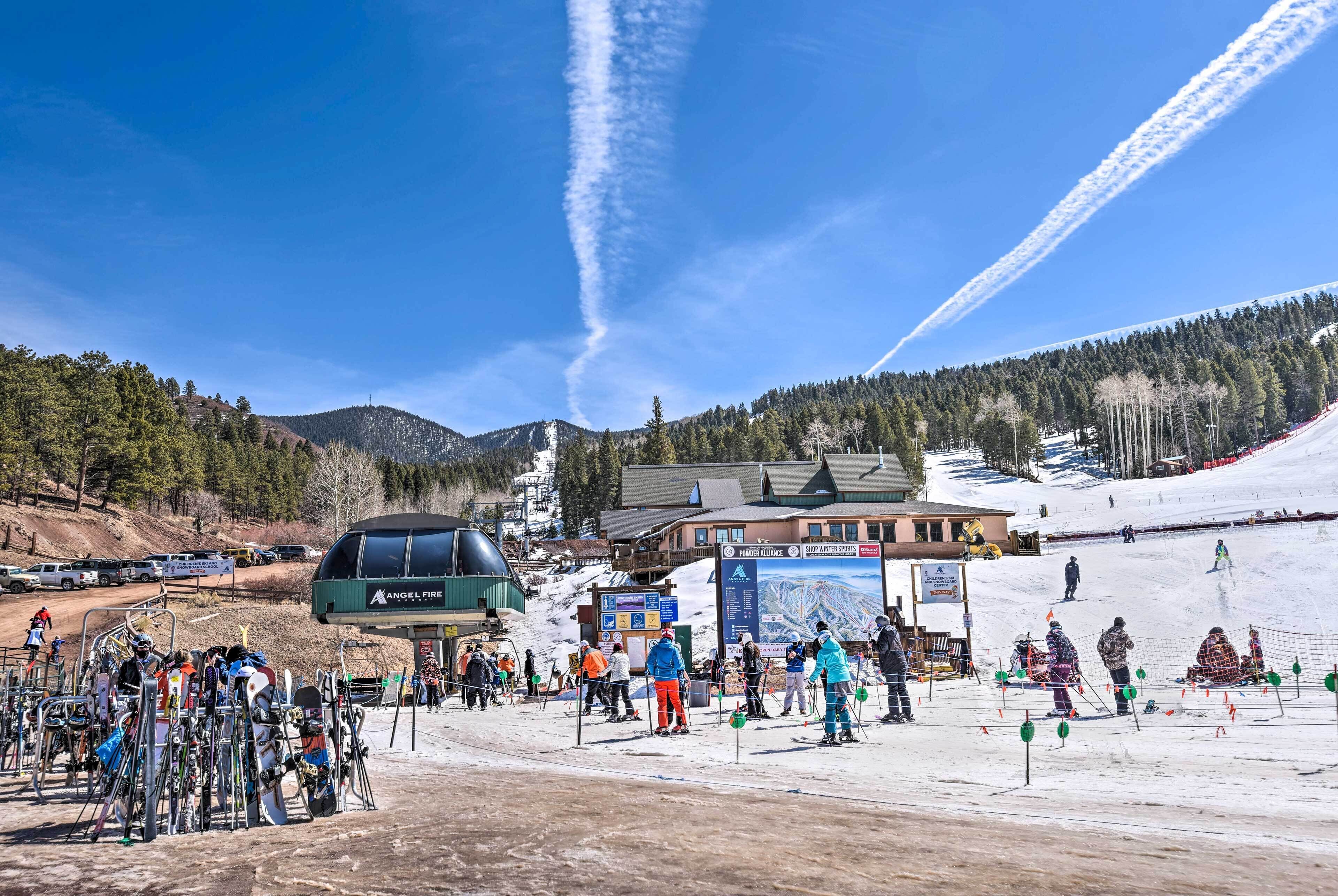 A ski resort with a chairlift, ski equipment, and a mountainous backdrop.