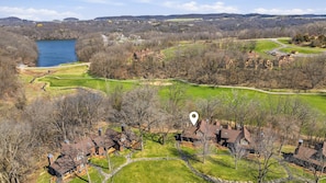 A residential area with houses, a lake, and a golf course.