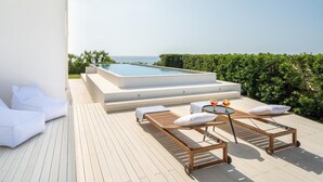 A rooftop pool area with a hot tub, lounge chairs, and a table with drinks. - Villa Finestrella, Seafront with pool (Arenella)
