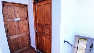 A wooden door with a sign reading "oficina" and a metal door handle.