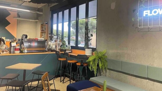 A cafe with a bar area, seating, and large windows. - Indigo Boutique Apartment-2 km to city  (Wayville)