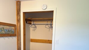 A room with a wooden dresser, a coat rack, and a picture on the wall. - Waterfront Two Bedroom Newly Built Cottage, Beach, Covered Deck, Firepits  (New Glasgow)