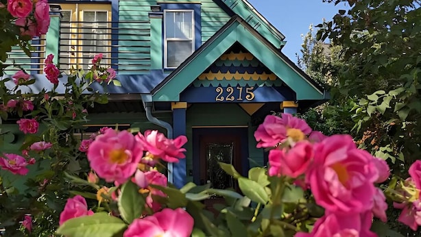 A house with a number 2215 on the front, surrounded by pink flowers. - Green Grove at Captain's Cove, located in the heart of Old Colorado City 2 (Colorado Springs)