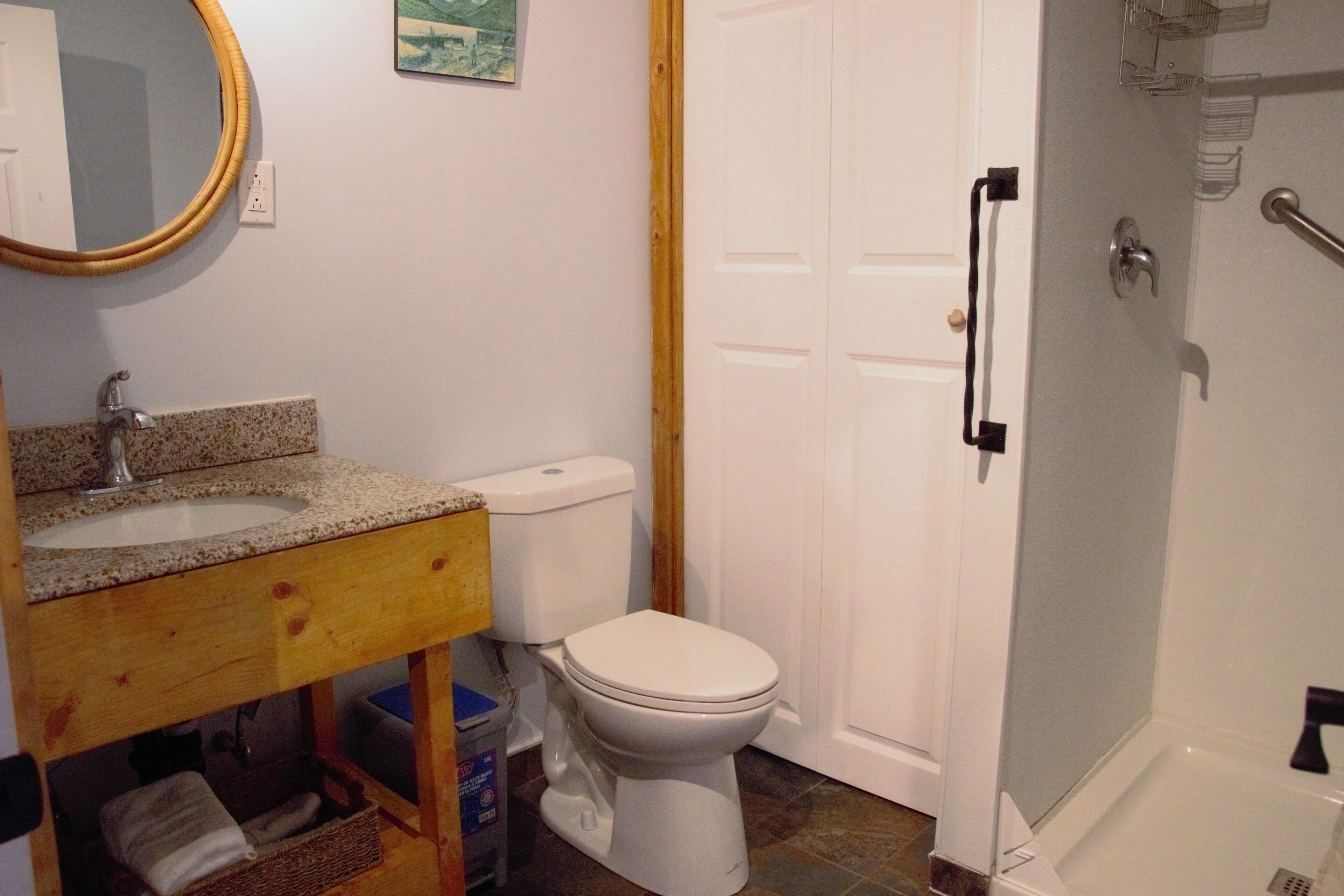A bathroom with a sink, toilet, and shower.