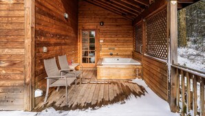 A wooden cabin with a wooden deck, a hot tub, and two chairs. - Hobart Peak Cabin w/ Jacuzzi and Wood Stove at Green Springs Inn (Ashland)