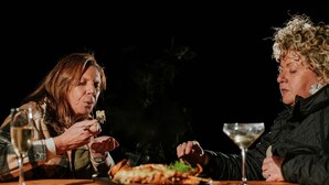Two people dining at a table with a plate of food and glasses of wine. - Scribbly Farm Premium Dome Bush retreat Southern highlands (High Range)