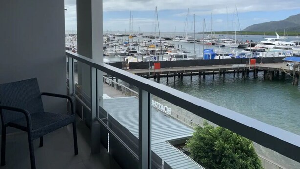 A balcony with a view of a marina filled with boats and yachts.