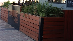 A Courthouse Hotel with a modern design, featuring a wooden facade and a signboard. - The Court House Hotel (Gunnedah)