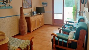 A living room with a television, a large vase, and a sofa. - Summer house close to the forest in L'Escala.HUTG-071512 (l'Escala)