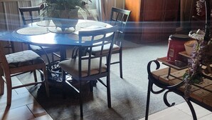 A dining area with a round table, chairs, a potted plant, and a fireplace. - Cabin on the Water! Cabin #5 (Noel)