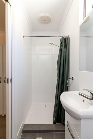Shower, rainfall showerhead, hair dryer, towels