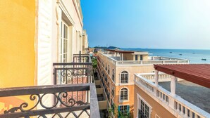 A balcony with a view of a beach and buildings. - Lotus Home Hillside (Phu Quoc)