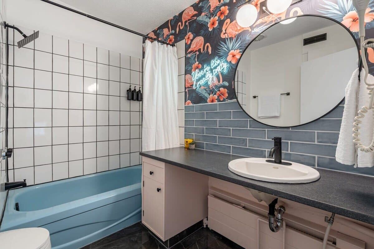 Bathtub, hair dryer, towels, shampoo