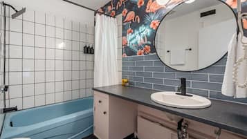 Bathtub, hair dryer, towels, shampoo