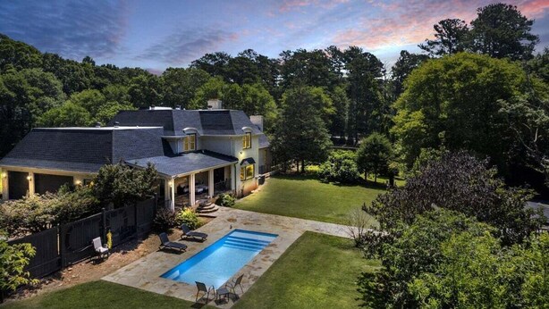 A two-story house with a covered patio, a swimming pool, and a well-maintained lawn. - The Wexford French Chateau w/ Pool (Athens)