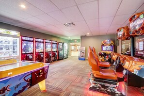 A row of arcade games with racing and racing-themed machines. - Grace-Jo @ Tamarack Highland 5 (Wisconsin Dells)