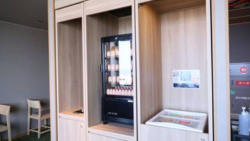 A compact kitchenette with a refrigerator, a small sink, and a microwave.