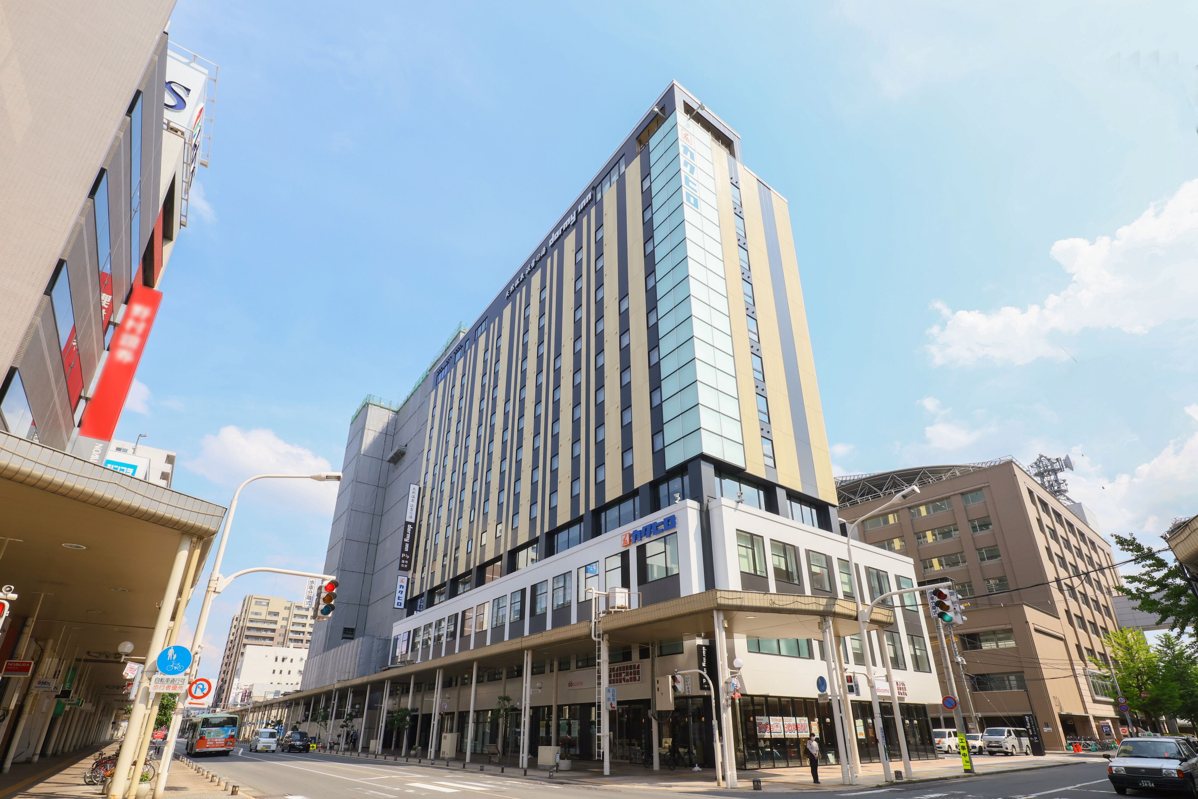 A modern hotel with a prominent vertical design, large windows, and a covered entrance area.