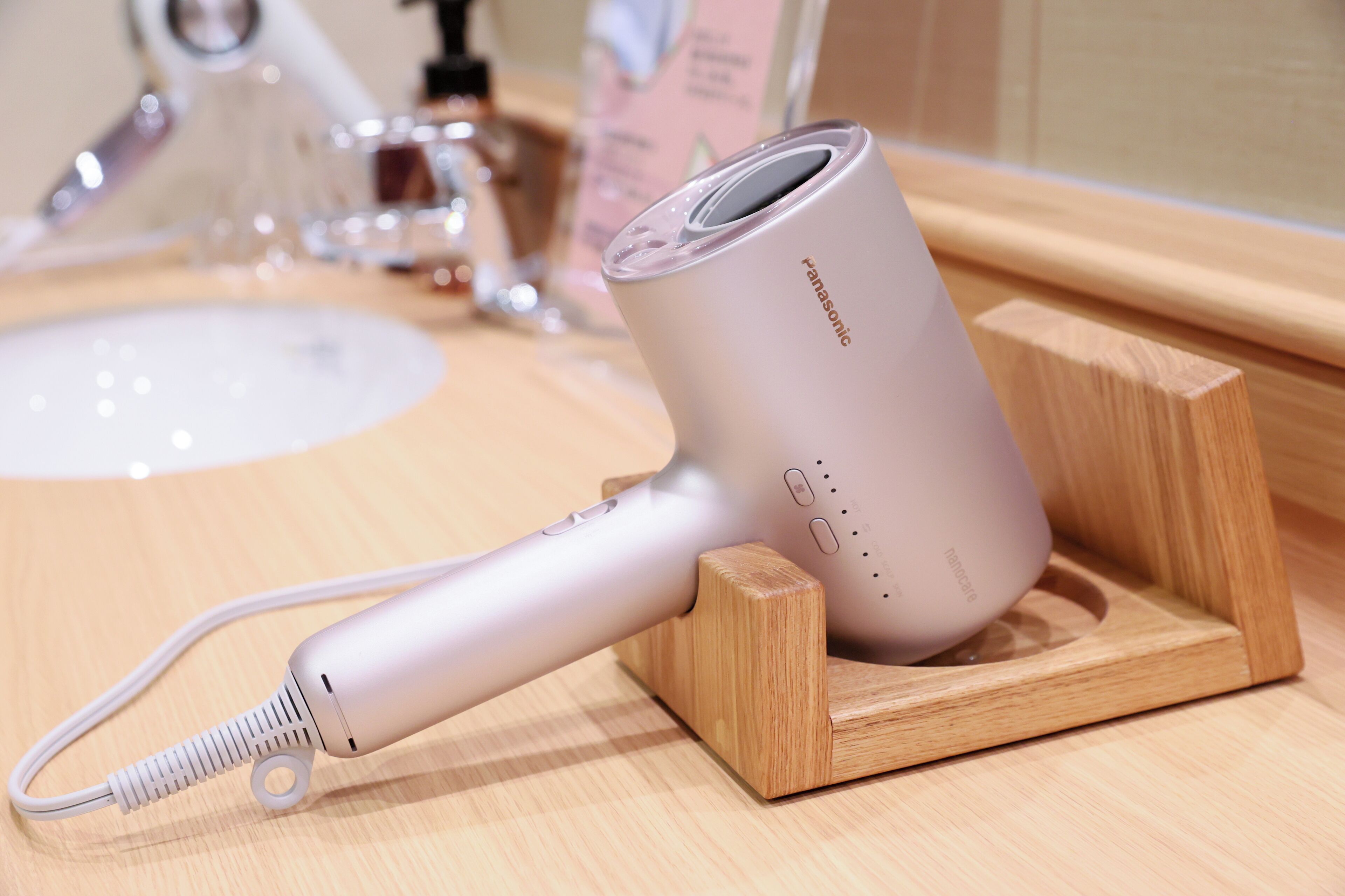 A Panasonic hair dryer on a wooden stand.