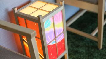 A wooden-framed, multi-panel lantern with illuminated panels.