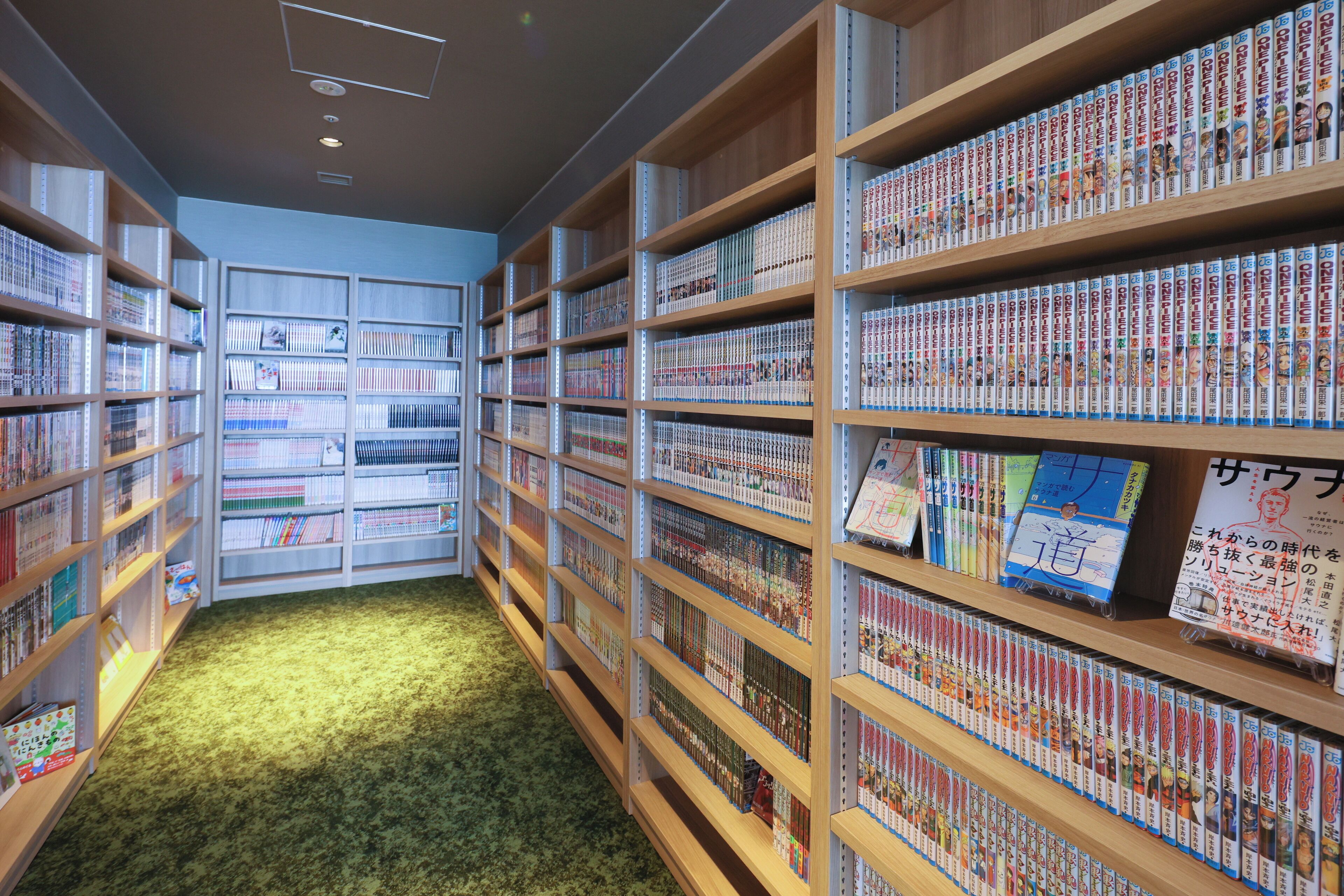 A library with bookshelves filled with books and manga.