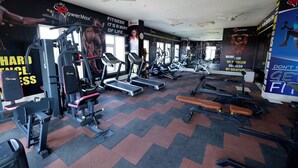 A gym with treadmills, weight machines, and benches. - MAHARAJA AGRASEN PALACE - PURE VEGETARIAN (Mawal)