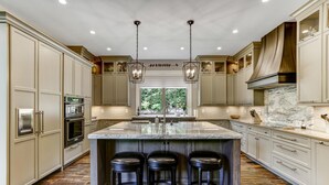 A spacious kitchen with a large island, bar stools, and modern appliances. - Nearly Six Private Acres. A Spring-Fed Trout Pond. Shortoff MountainViews | Shortoff Mountain View (Highlands)