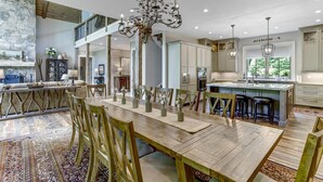 A spacious kitchen with a central island, wooden dining table, and modern lighting fixtures. - Nearly Six Private Acres. A Spring-Fed Trout Pond. Shortoff MountainViews | Shortoff Mountain View (Highlands)