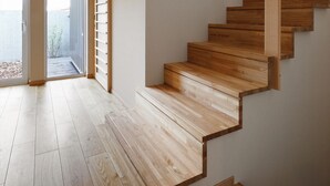 A wooden staircase in a modern interior with a view to a balcony. - AKATSUKI (Furano)