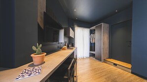 A modern kitchen with a wooden countertop, a potted cactus, and a patterned tile. - Nooria Sicilian Charme Rooms (Cefalù)