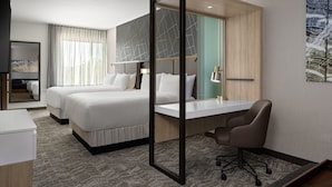 A hotel room with two beds, a desk, a chair, a mirror, and a painting on the wall. - Springhill Suites By Marriott Kalamazoo Portage (Portage)