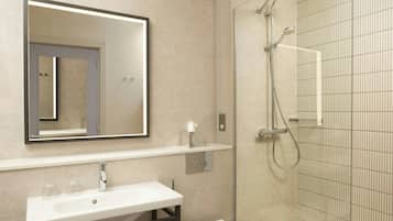 Een moderne badkamer met een grote spiegel, een witte wastafel, een toilet en een douche met glazen wanden.