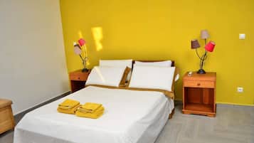 A hotel room with a bed, two bedside tables, and a nightstand.