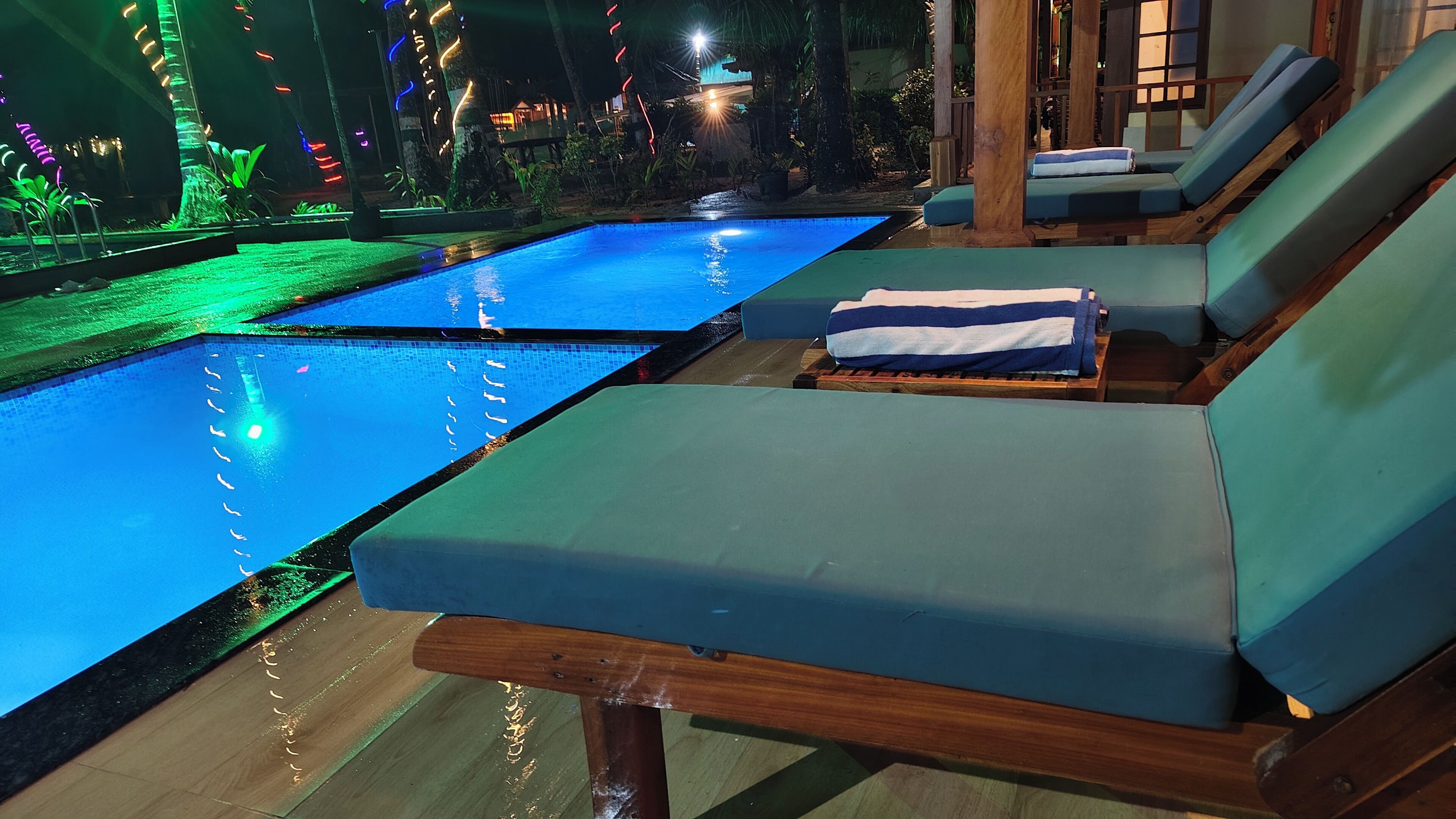 A poolside area with lounge chairs and a small pool.