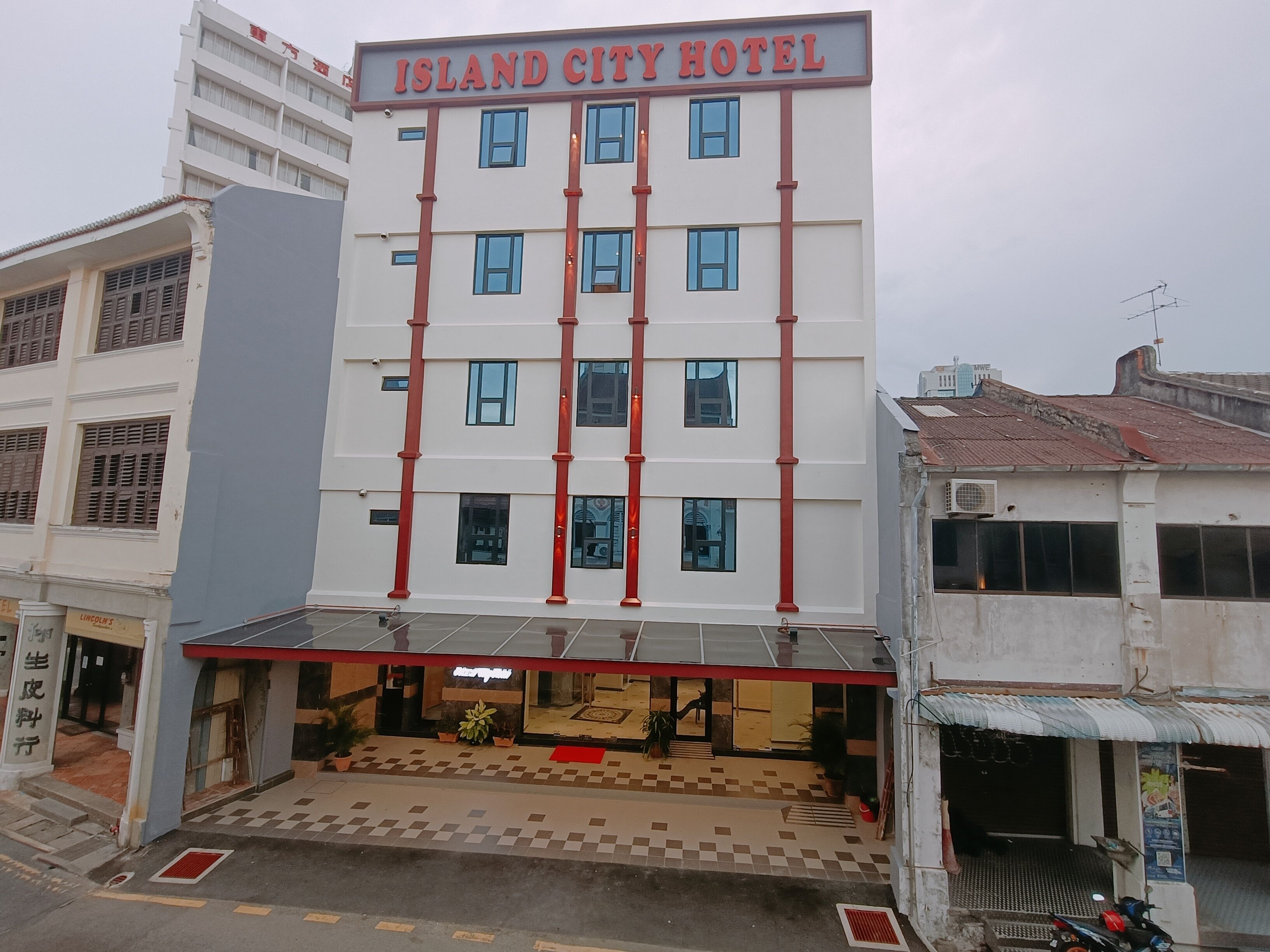 A multi-story hotel with a prominent sign reading "ISLAND CITY HOTEL".