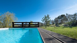 A swimming pool with a wooden deck, surrounded by trees and a clear sky. - Villa "Casa Romantica" with Shared Pool, 2 Private Terraces & Wi-Fi (Otranto)