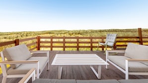 A deck with two white cushioned chairs and a table, overlooking a grassy landscape. - Deluxe Double Room B&B Villa with Shared Pool, Private Terrace and Wi-Fi (Otranto)
