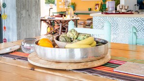 A dining table with a metal bowl containing fruits and a glass pitcher. - Deluxe Double Room B&B Villa with Shared Pool, Private Terrace and Wi-Fi (Otranto)