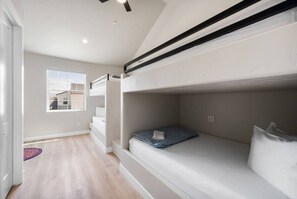 A bedroom with bunk beds, a window, and a view of buildings outside. - Sand Hollow Surf! Hang 10 and enjoy some fun in the sun! (Hurricane)