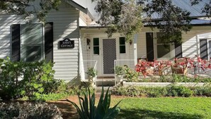 Une petite maison blanche avec une enseigne indiquant « Chez Josie » et le numéro « 59 » sur la porte.